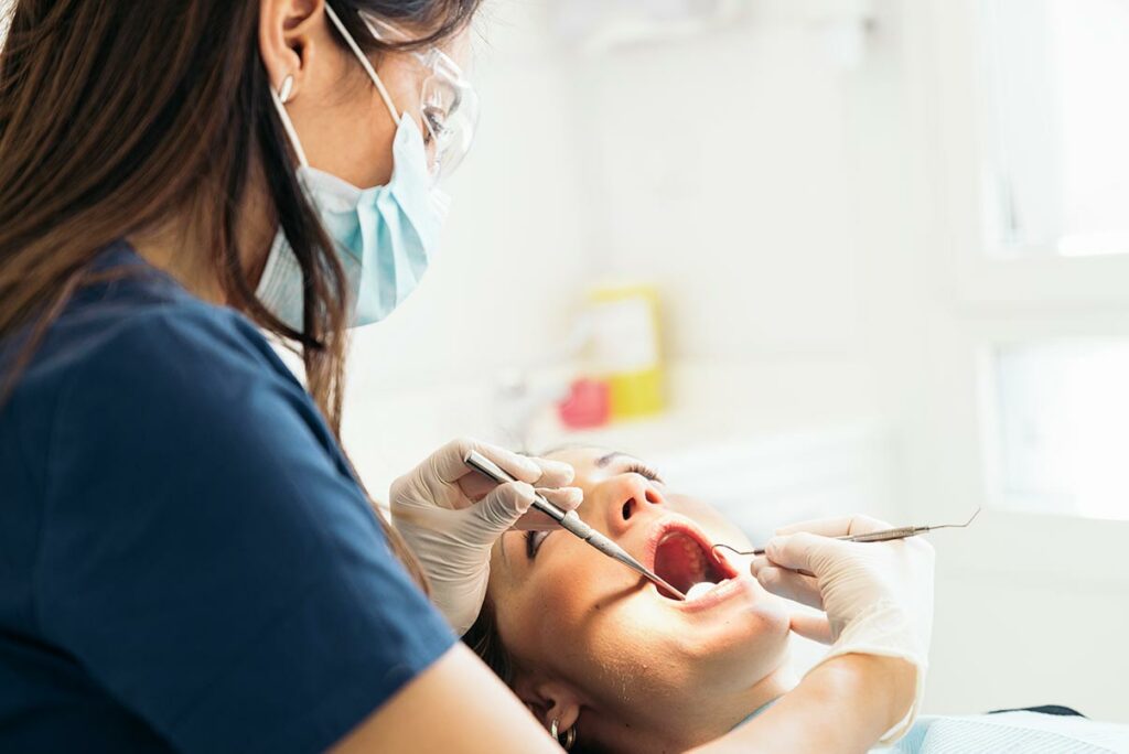 dentists with a patient during a regular dental check up